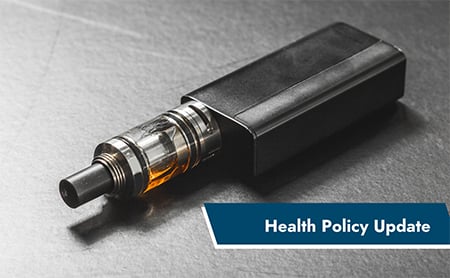 E-cigarette on a black table. ASTHO Health Policy Update banner in lower right