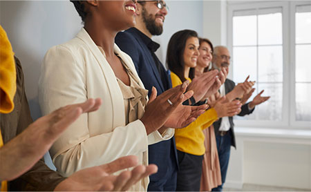 close-up-diverse-multiracial-businesspeople-clapping-hands_450x278.jpg