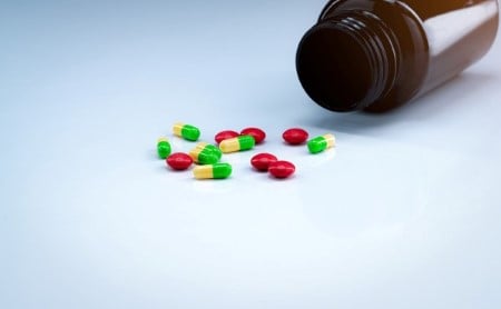colorful-capsules-pills-spilling-out-brown-bottle_1200x740.jpg