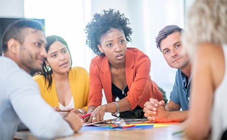 A group of coworkers in a meeting collaborate on a project