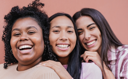 diverse-trio-of-women-friends-smiling-at-camera_1200x740.png