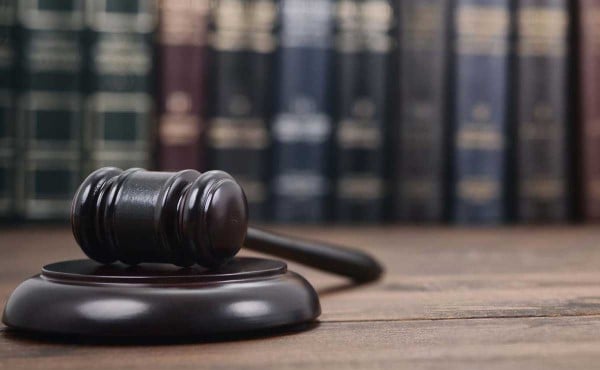 Judge Gavel and Law books on a wooden background.
