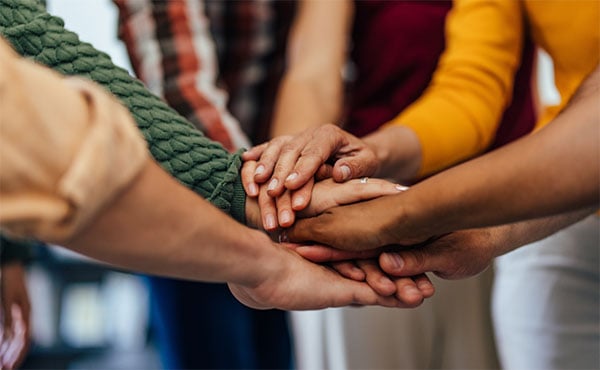 Diverse hands piled on top of each other