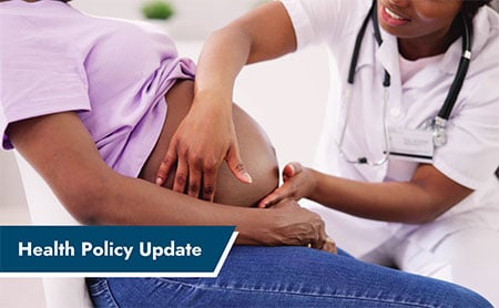 A doula is examining a pregnant person’s belly, with the text ‘Health Policy Update’ displayed in the bottom left corner.
