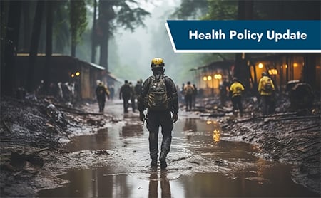 Health Policy Update: Firefighter walking away in muddy field with standing water