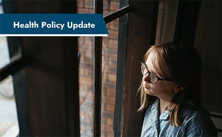 A sad young girl with glasses looks out of a window in an otherwise dark room. ASTHO Health Policy Update banner in the upper left