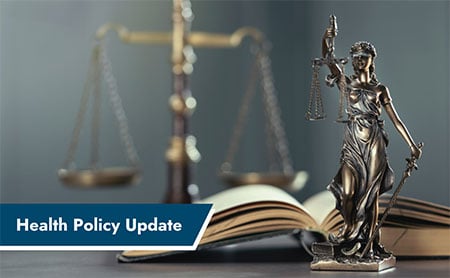 Small bronze statue of Lady Justice in foreground with book and scales in the background with a banner in the lower left with the text, Health Policy Update