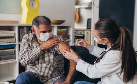 Healthcare worker vaccinating patient