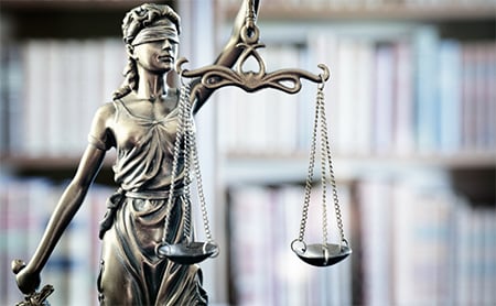 Close-up of bronze Lady Justice statue in library