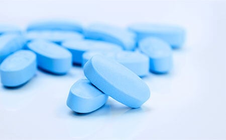 A pile of light blue pills