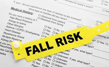 Fall risk hospital bracelet on top of medical history form