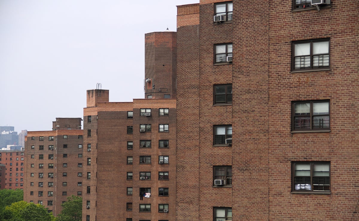 A row of brown brick residential buildings in lower Manhattan