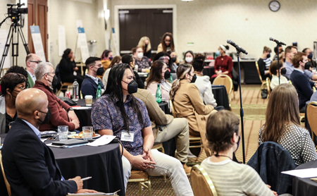 STRETCH conference attendees in 2023, listening to a speaker