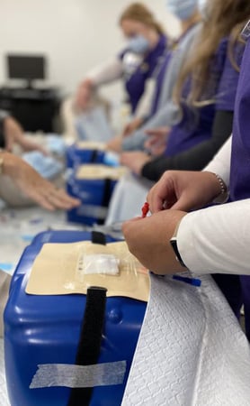 Mannequin station where training participants practice placing a central venous catheter into a patient’s chest