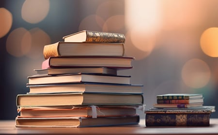 Two piles of old, hardcover books
