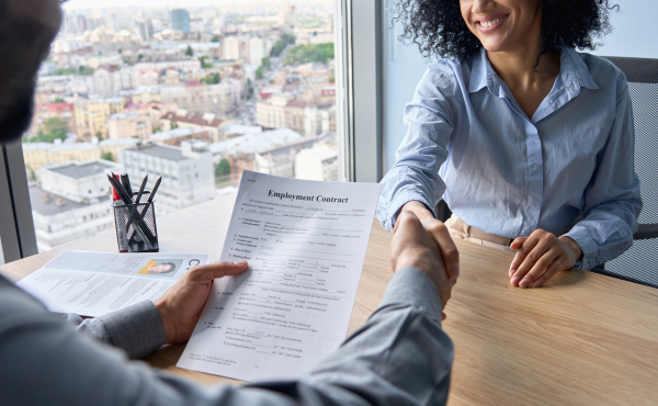 Woman of color shaking hands with her new employer