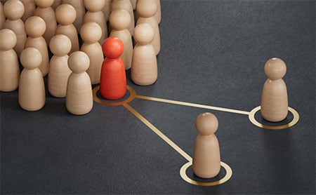 A red pawn figure connects to two wooden figures through yellow lines.